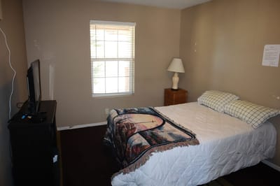 Cozy private bedroom with a bed and lamp