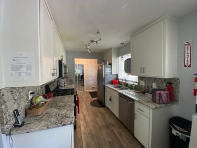 A kitchen area with granite countertops and appliances