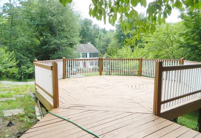 Outdoor deck area surrounded by greenery