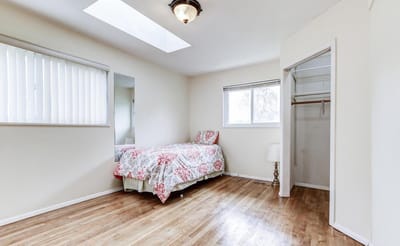 Bright, inviting resident room with floral bedding