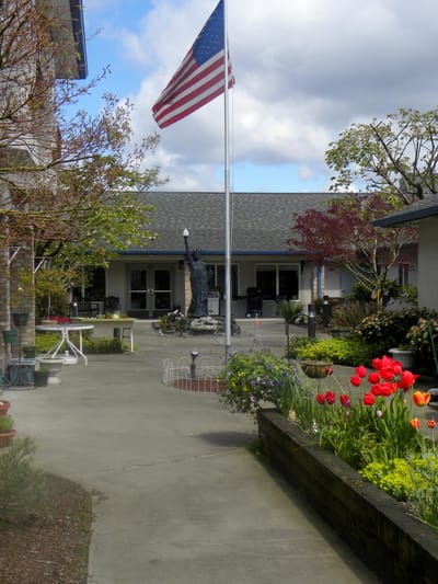Outdoor space with flowers and American flag