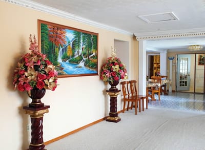Decorated hallway with art and floral arrangements