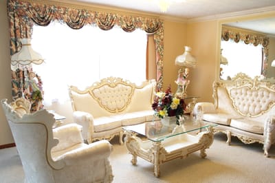 Elegant common area with ornate furniture and floral curtains