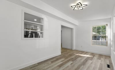 Bright, empty interior room with wooden floors