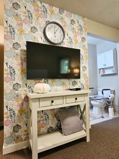 Cozy interior space with a television and decorative wall.