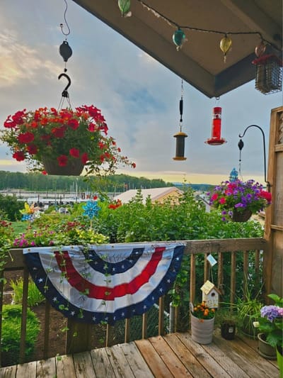 Colorful flowers and hanging decorations on a porch