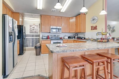 Bright kitchen area with granite countertops