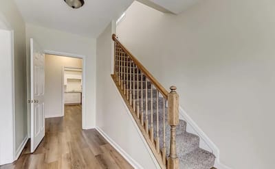 Bright, empty hallway with stairs in a facility