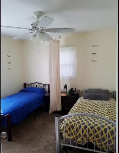 Private resident room with two beds and decor