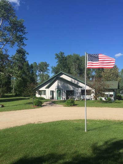 Exterior view of a senior living facility with a flag