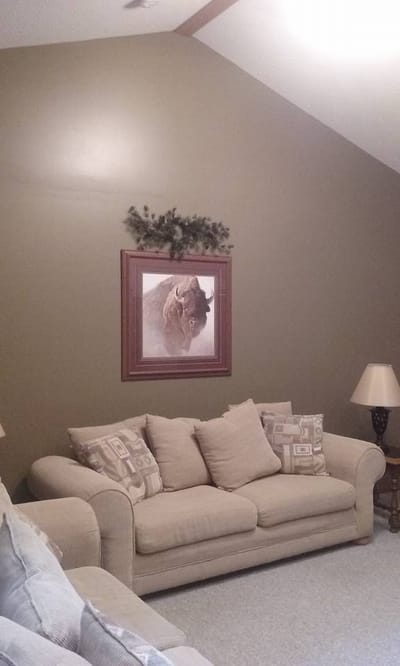 Living room with beige couch and wall art