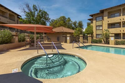 Outdoor pool and spa area at a senior living facility