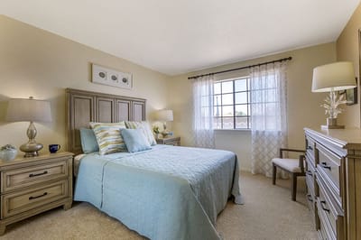Cozy bedroom with a blue theme and natural light