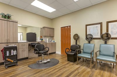 Hair salon area with styling chairs and mirrors