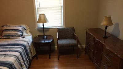 Cozy resident room with furniture and lamp