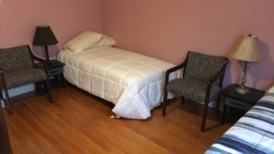 A private room with two beds and seating
