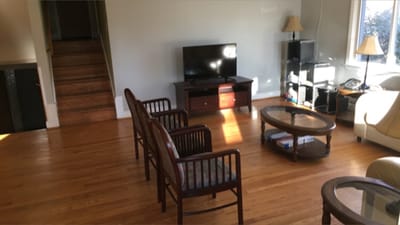 Bright common area with seating and a television
