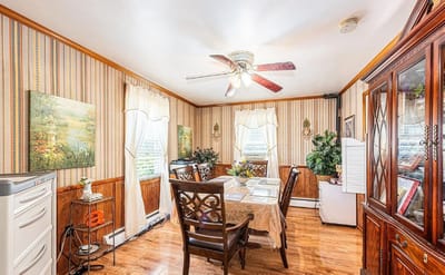 Bright dining area with wooden furniture and decorative walls