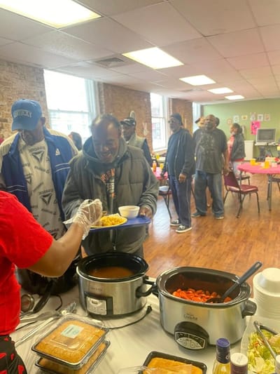 Residents being served food in a common area