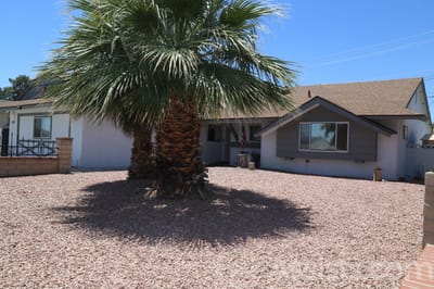 Exterior view of a senior living facility with palm trees