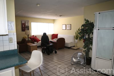 Common area with seating and a resident in a power wheelchair