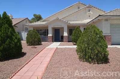 Health Life, assisted living in Las Vegas, NV — House exterior with a landscaped pathway and greenery