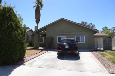 Exterior view of a residential facility with a parked car