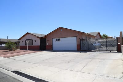 Exterior view of a group home with a gated entrance