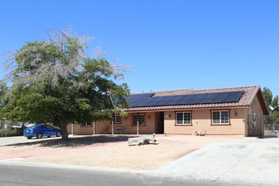 Exterior view of a senior living facility with solar panels