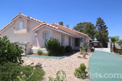 Carmela Homes, assisted living in Las Vegas, NV — Residential building with landscaped front yard and driveway