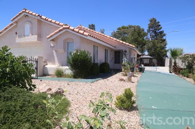 Carmela Homes, assisted living in Las Vegas, NV — Single-story house with a landscaped front yard