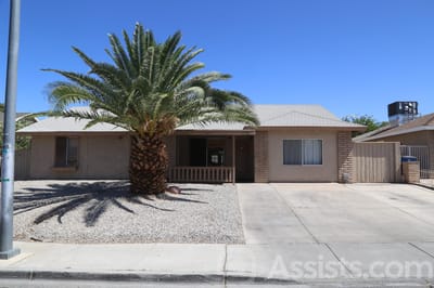 Prime Care Facilities, assisted living in Las Vegas, NV — Single-story home with palm tree and gravel landscape