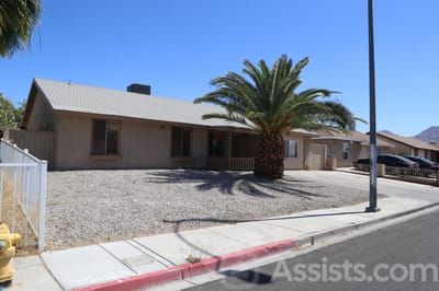 Prime Care Facilities, assisted living in Las Vegas, NV — Single-story house with palm tree and gravel yard