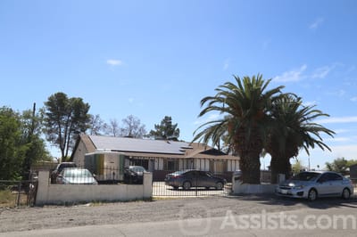Exterior view of a senior care facility with palm trees