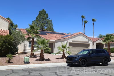 Beachport Villa, assisted living in Las Vegas, NV — Residential building with palm trees and parked car
