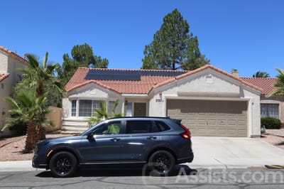 Beachport Villa, assisted living in Las Vegas, NV — Modern single-family home with solar panels and SUV