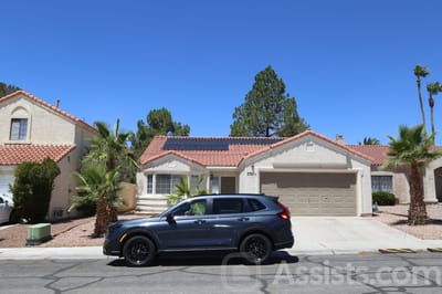 Beachport Villa, assisted living in Las Vegas, NV — Single-family home with palm trees and a parked car