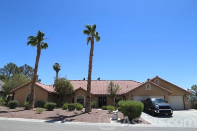 Exterior view of Bella Estate Care Home with palm trees