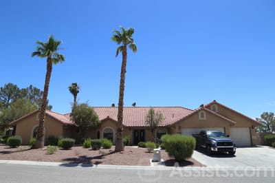 Exterior of Bella Estate Care Home with palm trees