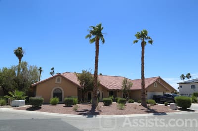 Exterior view of Bella Estate Care Home with palm trees