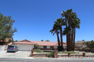 Exterior view of a residential facility with palm trees