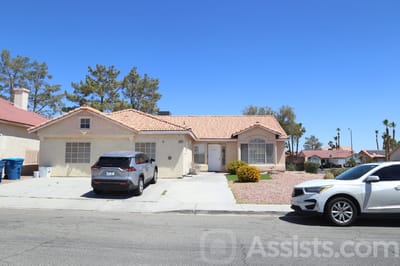 Exterior view of a residential-style facility with cars parked