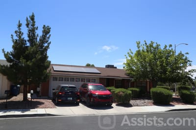 Exterior view of a senior care home with parking