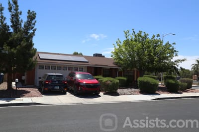Exterior view of Nelsie’s Care Home with parked cars