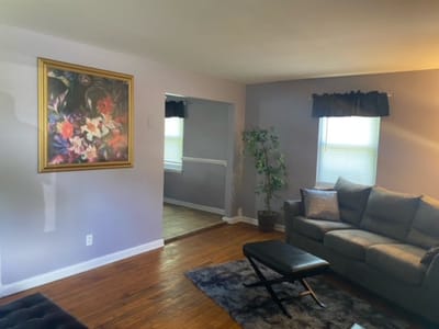 Bright interior of a common area with a couch and artwork