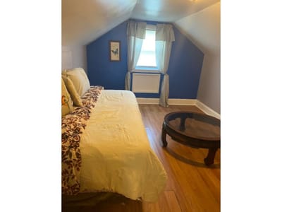 Bright private bedroom with a bed and coffee table