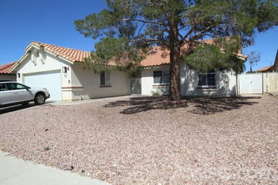 We Care Residential Home, assisted living in Las Vegas, NV — Single-story residential home with a large tree and driveway