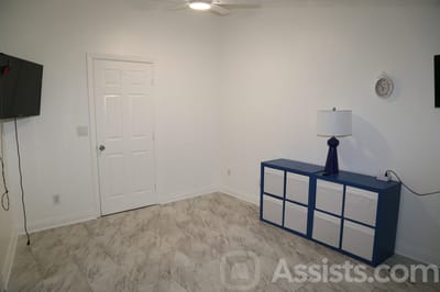 We Care Residential Home, assisted living in Las Vegas, NV — Empty room with a blue cabinet and wall clock