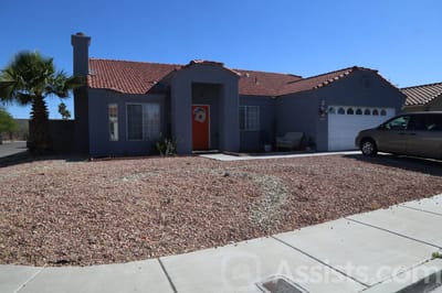Ross Senior Residence, assisted living in Las Vegas, NV — Single-story home with a red door and desert landscaping