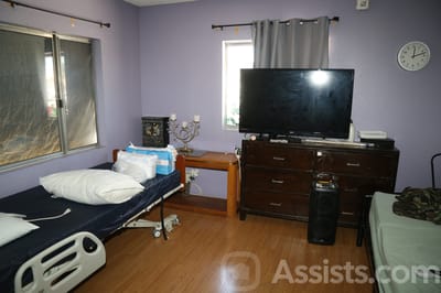 A private resident room with a bed and television